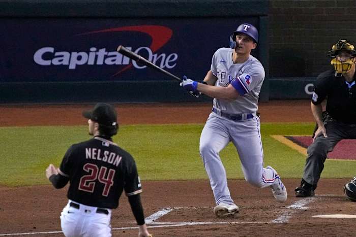 Oct 31, 2023; Phoenix, Arizona, USA; Texas Rangers shortstop Corey Seager (5) hits a two run home run against the Arizona Diamondbacks during the second inning in game four of the 2023 World Series at Chase Field. Mandatory Credit: Rick Scuteri-USA TODAY Sports